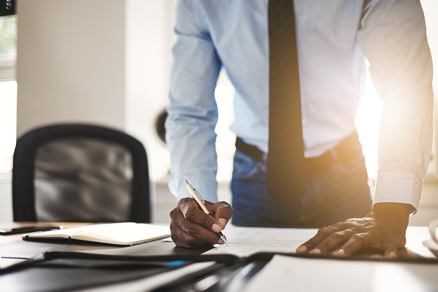lawyer standing at desk signing papers palatka fl
